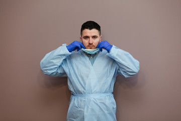 doctor wearing respiratory mask coronavirus epidemic with protective gesture. Healthcare concept.
