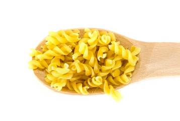 pasta in a wooden spoon on a white background. View from above.