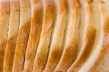 sliced white bread, closeup bread texture. Background of slices of loaf.