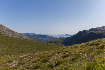 landscape of the northern mountains in summer from which we can see the sea on a clear day