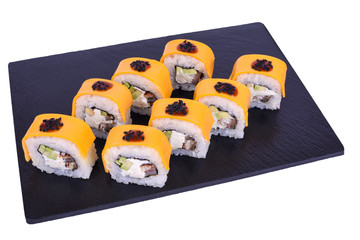 Traditional fresh japanese sushi rolls on black stone Unagi cheeses on a white background. Roll ingredients: eel, philadelphia cheese, cheddar cheese, avocado, Unagi sauce, nori, rice, black sesame.
