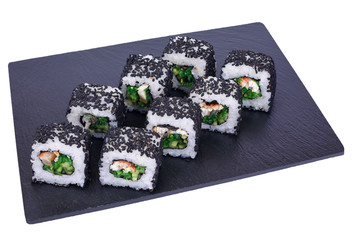 Traditional fresh japanese sushi rolls on black stone Unagi night on a white background. Roll ingredients: eel, philadelphia cheese, cucumber, hiyashi wakame seaweed, nori, rice, black sesame.