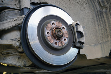 Brake disc, brake caliper mounted on a modern car. Concept of service and car repair.