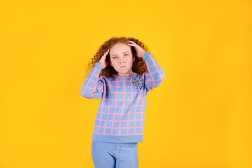 red-haired girl on a yellow background, headache