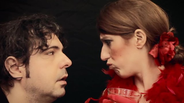 A poor, sleepy, tired man forced to listen to a chatty attractive woman at a party. Funny comedy shot.