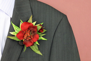 A artificial floral wedding buttonhole on a suit