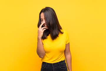 Young brunette girl over isolated background smiling a lot