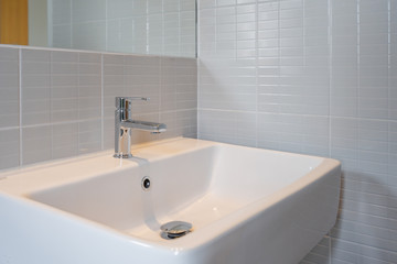 Modern faucet and white ceramic washbasin sink bathroom interior office building or home and living decoration