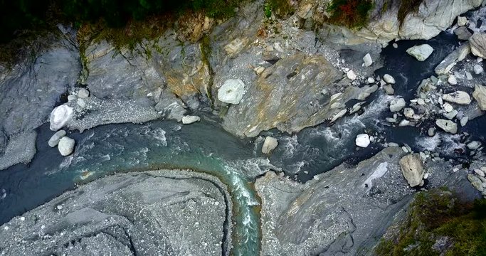 Aerial footage of mountainous river/stream with rocks and stones in the Taroko national park/gorge.