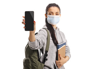 Fototapeta na wymiar Female student wearing a medical mask and showing a smartphone to the camera