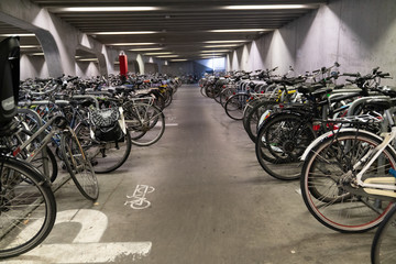 Fototapeta na wymiar Ghent/Belgium - October 10, 2019:Bicycle parking under the bridge in the heart of Ghent, Belgium