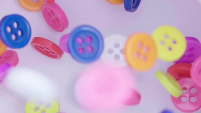 Buttons colorful couture, close up. Fall in slow motion.