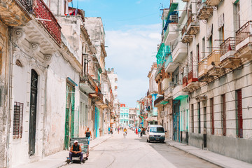 Authentic view of a street of Old Havana with old buildings and cars