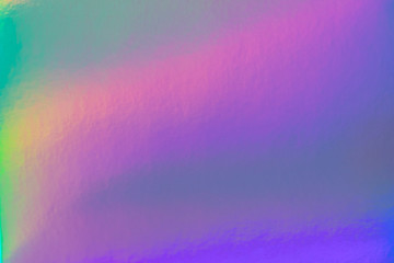 Abstract trendy rainbow holographic background in 80s style. Blurred texture in violet, pink and...