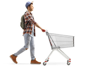 Male student pushing an empty shopping cart © Ljupco Smokovski