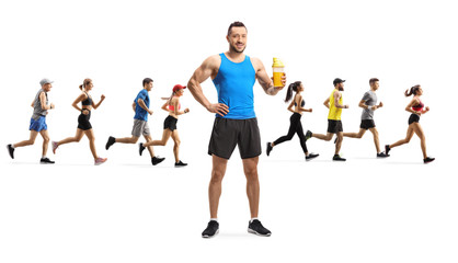 Fit young man holding a protein shake and people running in the back