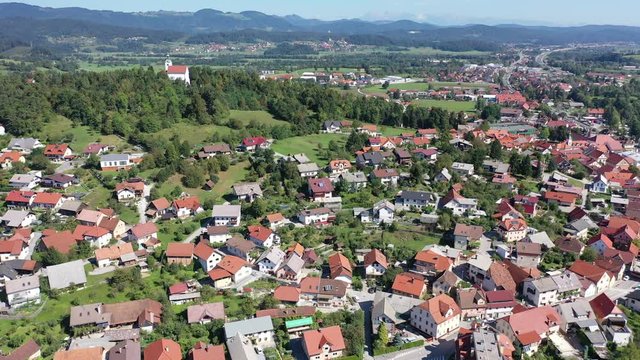 Picturesque autumn landscape of Ljubljana Marshes overlooking brownish roofs of houses of small Slovenian town of Vrhnika