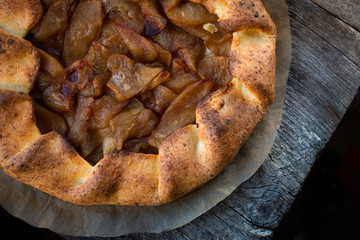 Cottage cheese dough galette with apples. .Curd dough galette with apples on wooden background. Apple crostata. Open pie. Homemade