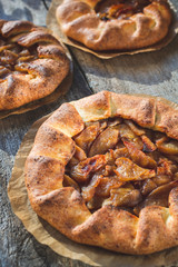 Cottage cheese dough galette with apples. .Curd dough galette with apples on wooden background. Apple crostata. Open pie. Homemade