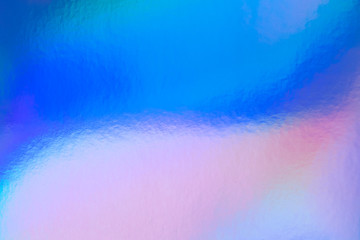 Abstract trendy rainbow holographic background in 80s style. Blurred texture in violet, pink and...