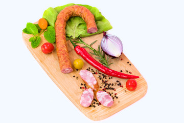 Smoked sausage on a white plate with peperoni