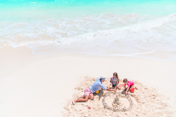 Fototapeta na wymiar Happy beautiful family on a tropical beach vacation