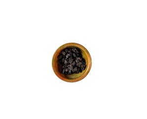 Raisins in a clay bowl on white background. healthy food concept