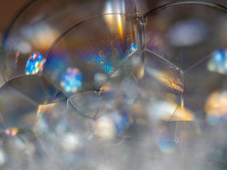 Fototapeta na wymiar abstract macro of soap bubbles with colorful reflection of light