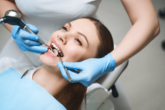 Young woman treating teeth in clinic stock photo