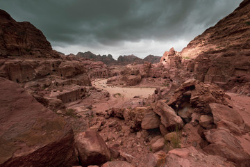 The ancient Nabatean  city of  Petra in Jordan, a main road in street of facades among sandy mountains in the desert in stormy weather
