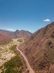 Andes Mountains, Cerro de los Siete Colores, Purmamarca Jujuy, Argentina colourful rock formation village and blue sky