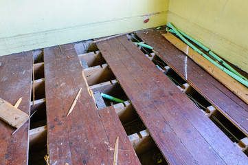 Floorboards lifted by thieves attempting to steal copper heating pipes
