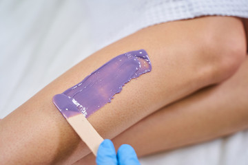 Focused photo on female legs that being on procedure