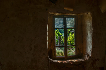 Fototapeta na wymiar Old rural abandoned house window view fom inside