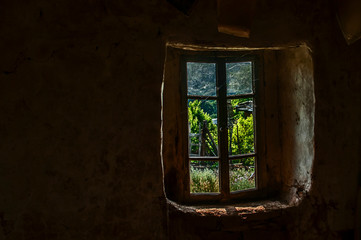 Old rural abandoned house window view fom inside