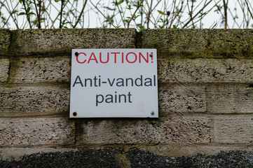 Sign on a wall warning of the presence of anti-vandal and anti-climb paint