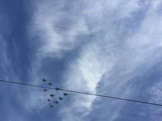 during  military parade in Moscow military planes fly in formation in the blue sky