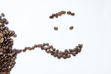 Smile from coffee beans, on a white background. View from above.