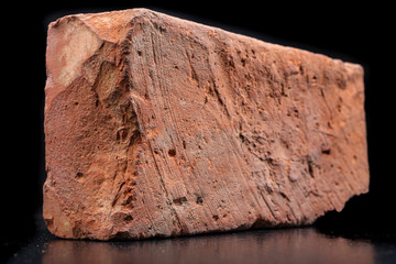 Red brick made of baked clay. Material for home building materials.