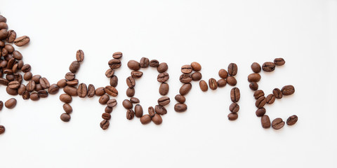 Coffee beans in the shape of the word Home, on a white background.