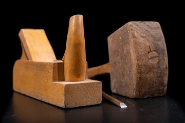 Joiner's planer, wooden hammer and chisel. Carpentry accessories in the workshop.