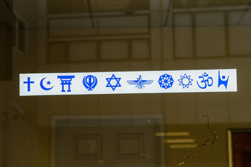 Sign on the window of a multi-faith religious building