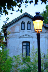 Old house at dusk with a street lamp