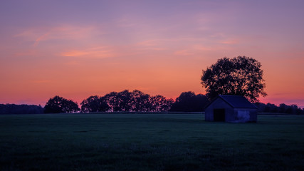 Sunset at a Dutch farm landscape near the village of Zenderen. It lies in the region of Twente (in...
