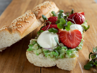 sandwich baguette with strawberries mozzarella cheese and guacamole closeup