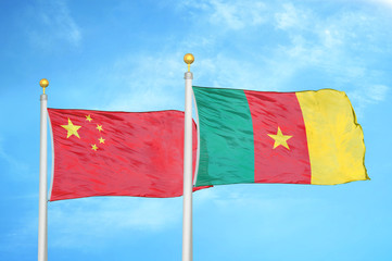 China and Cameroon two flags on flagpoles and blue cloudy sky