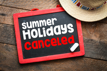 HOLIDAYS CANCELED words written on a chalk board.