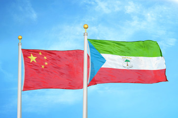China and Equatorial Guinea two flags on flagpoles and blue cloudy sky