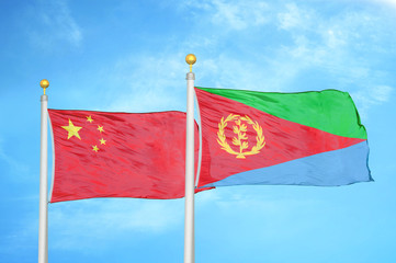 China and Eritrea two flags on flagpoles and blue cloudy sky