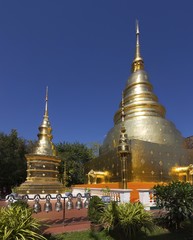 Naklejka premium Giant Buddhist Chedi Stupa Monuments at Wat Pra Singh Golden Temple Complex in Chiang Mai, Thailand